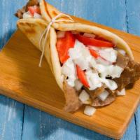 Yeero (Gyro) · The hamburger of Greece! A mixture of lamb and beef cooked on a vertical rotisserie, sliced ...