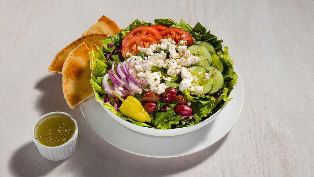 Classic Greek Salad · Fresh mix greens, tomatoes, cucumbers, red onions, pepperoncinis, calamata olives, feta cheese, and our tasty Greek dressing. Served with pita bread.