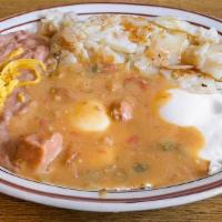 Huevos Rancheros · Two eggs smothered with green chile, fried potatoes, refried beans, and two tortillas.