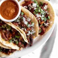 Taco Plate · Tacos Al Pasto (pictured):. Marinated pork tacos filled with fresh onion, pineapple, and cil...
