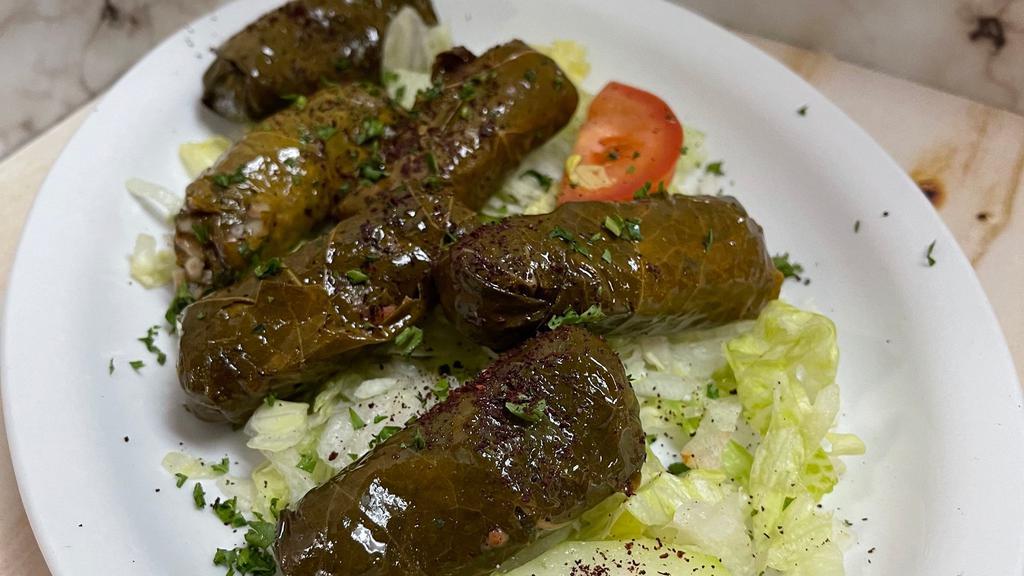 Dolmas · Grape leaves stuffed with rice tomato onion parsley & spices