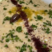 Baba Ghanoush · Roasted mashed eggplant mixed with tahini sauce fresh garlic & spices - served with pita