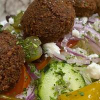 Falafel Salad Bowl · Five pieces of falafel over our Greek salad