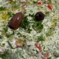 Jerusalem Salad · Fresh tomato & cucumber mixed into our creamy tahini sauce