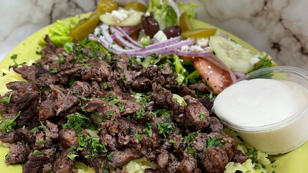 Beef Shawarma Plate · Thinly sliced marinated boneless beef mixed with our special spices - served with salad rice & pita