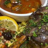 Lamb Shank · Tender lamb shank blended with our special spices - served with okra soup rice & pita