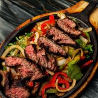 Fajitas *Gf · Choice of meat sautéed with grilled marinated onions, bell peppers, in a light red sauce. Co...
