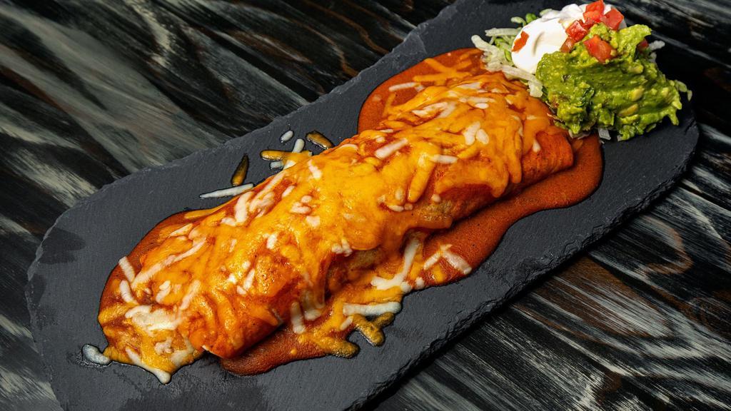 Big Boy Burrito · Large flour tortilla smothered in classic red
enchilada sauce and melted cheese. Filled with
Spanish rice, refried beans and your choice
of chicken or ground beef. Served with lettuce,
tomato, and THE WORKS