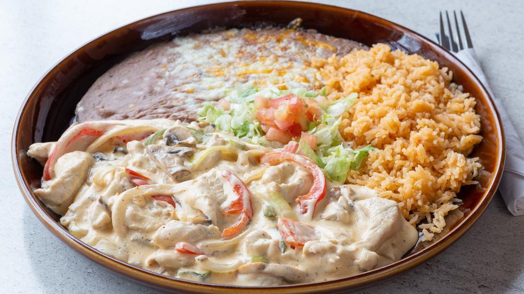 Pollo A La Crema *Gf · Tender pieces of chicken breast with sautéed
onions, bell peppers, and mushrooms in a
creamy sauce with Mexican crema