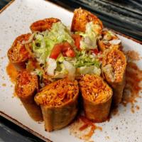 Corn Taquitos · Just the perfect amount of crunch! Corn tortillas
filled with shredded chicken. Topped with ...