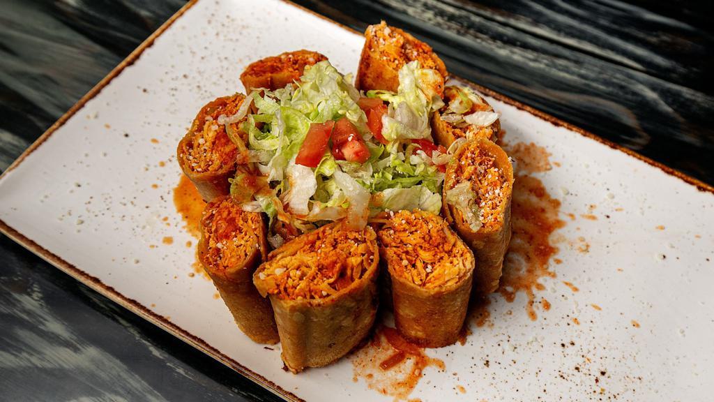 Corn Taquitos · Just the perfect amount of crunch! Corn tortillas
filled with shredded chicken. Topped with lettuce,
tomatoes, queso fresco, and THE WORKS