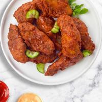 Our Nashville Hot Wings · Fresh chicken wings fried until golden brown, and tossed in our house Hot Sauce. Served with...