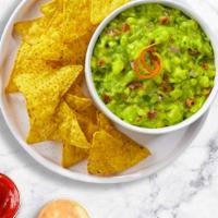 Chips & Guacamole · A heaping scoop of fresh guacamole and warm tortilla chips.