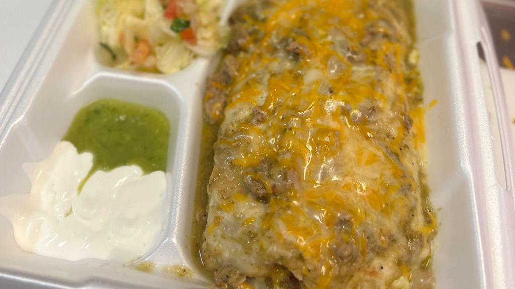 Smothered Burrito · Burrito filled with rice, beans and your choice of protein. topped with green sauce and cheese. with a side of lettuce, sour cream and guacamole salsa.