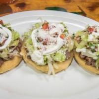 Sopes · 3 home made deep fried tortillas, topped with beans, protein, lettuce, pico, guacamole salsa...