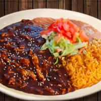 Pollo En Mole · Spicy! Not sweet. Chicken breast strips cooked in a spicy mole sauce, mushrooms and onions. ...