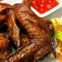 Fried Chicken Wings · Deep fried chicken wings marinated and served with sweet chili sauce.