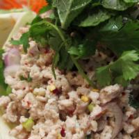 Larb Gai · Minced chicken and roasted rice tossed with green onions, shallots, and cilantro. (Gluten Fr...