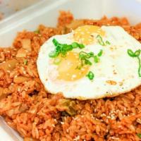 Kimchi Fried Rice · Spicy Korean fried rice with kimchi, spam, and pork belly, topped with two fried eggs.