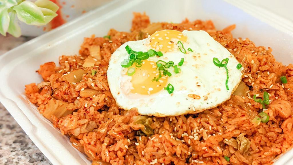 Kimchi Fried Rice · Spicy Korean fried rice with kimchi, spam, and pork belly, topped with two fried eggs.