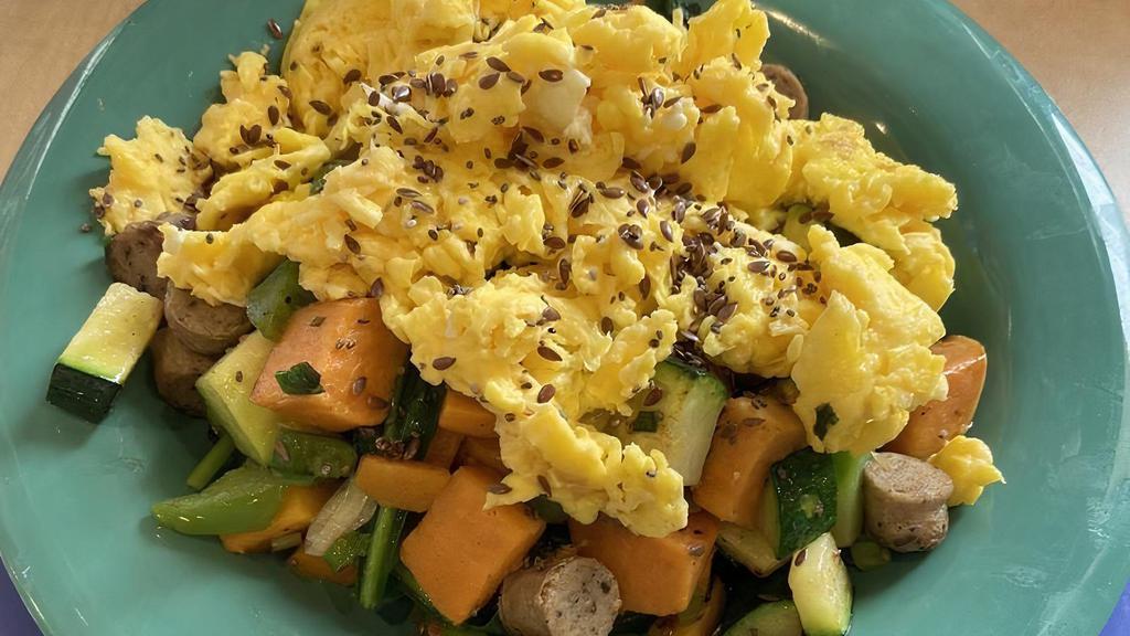 Sweet Potato Breakfast Bowl · Sweet potatoes, green onions, zucchini, green bell peppers, spinach and your choice of protein, topped with two eggs any style and a sprinkle of our flax & chia seed blend.