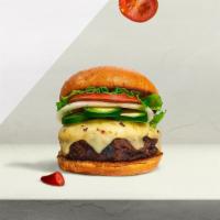 Call Me Caliente Burger · Seasoned half-pound angus patty perfectly cooked to medium, topped with melted cheese & spic...