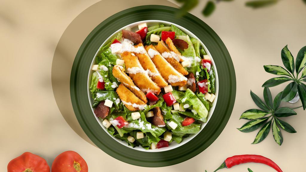 Crispy Chicken Salad · Our signature crispy fried chicken sliced and served over fresh greens, with tomato, onion, croutons, avocado, and shredded cheese. Served with your choice of dressing.