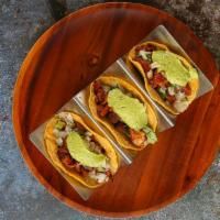 Tacos Al Pastor · Served with chopped onions with cilantro, and guacamole salsa
