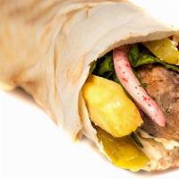 W3 Lamb Kebab (Kafta) · Char-Grilled Lamb Kebab (Kafta) with hummus, onion, parsley, sumac, pickles, fries, and toma...