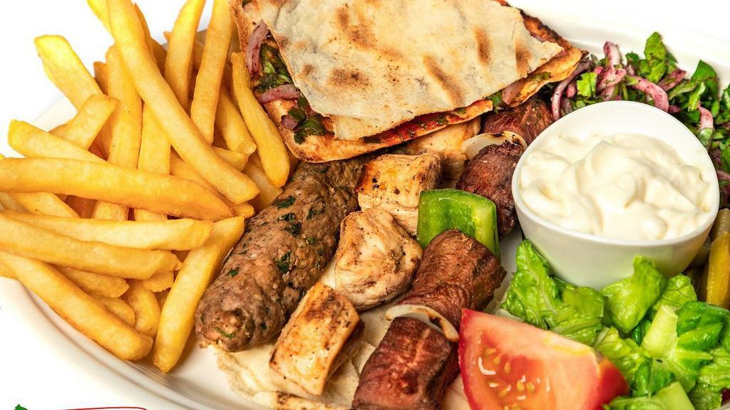 Mixed Grill · Char-grilled tenderloin 4 pcs, chicken tawook 4 pcs, kebab 1 skewer. Served with vegetables, pickles, pita bread, garlic sauce, tahini sauce, rice, or fries.