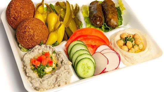 M6 Vegan Platter · Vegan. Falafel 2 pcs, Dolma 2 pcs, Hummus, Baba Ghanoush, Vegetables, Pickles, and pita bread.