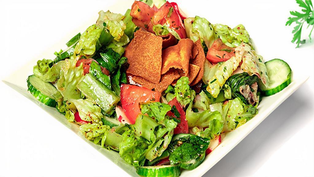Green Salad · Vegan. Lettuce, tomatoes, cucumber, onions, parsley, mint, radish, green pepper, lemon, and olive oil.