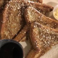 French Toast · Thick cut Texas toast battered, griddled and dusted with powdered sugar, served with butter ...