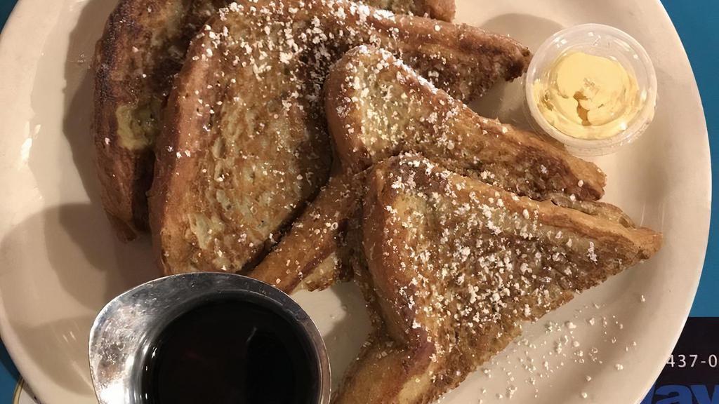French Toast · Thick cut Texas toast battered, griddled and dusted with powdered sugar, served with butter on the side and your choice of maple or boysenberry syrup.