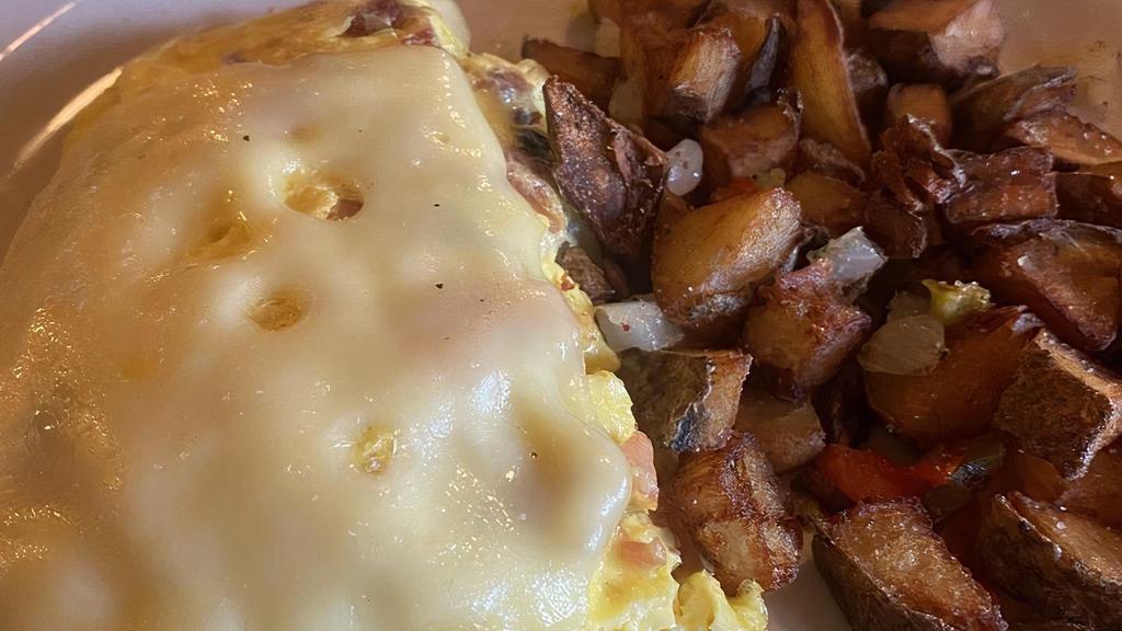 The Peppersauce Omelette · Farm fresh eggs loaded with a center of cream cheese, bacon, ham, peppers, onions and tomatoes topped with Swiss cheese.
