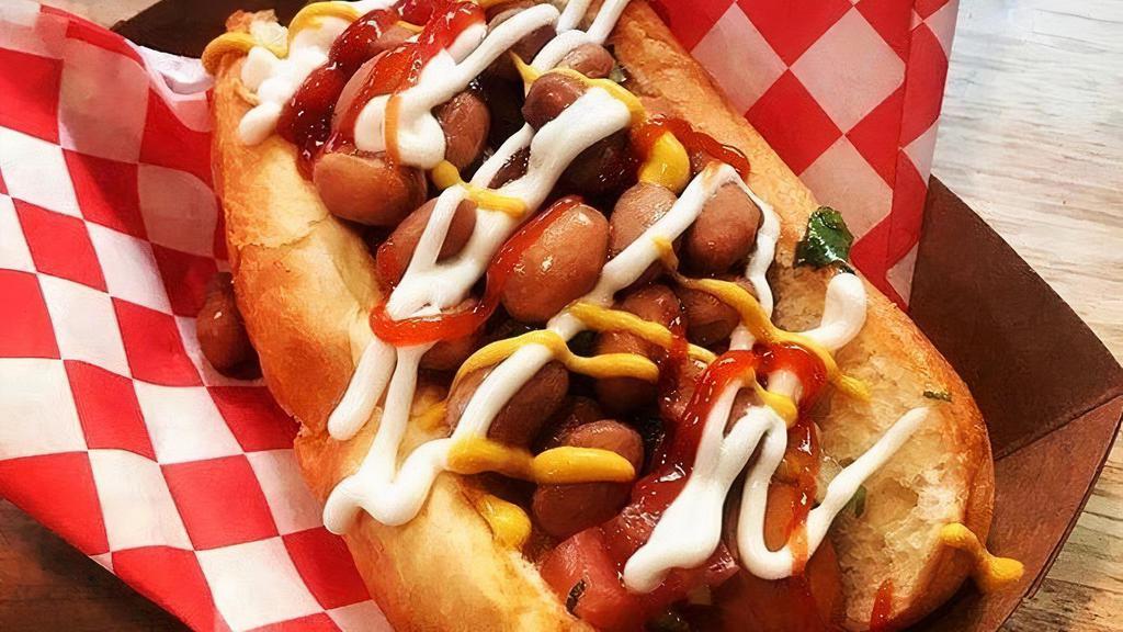 Sonoran Dog · Vegan hot dog with organic salsa, pinto beans, pickled onions, vegenaise, mustard, vegan Bac’Un bits, organic bun.