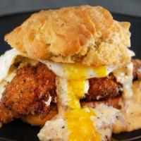Two Birds And A Biscuit · Turkey sausage gravy, fried chicken breast, & a fried egg sandwiched in a homemade buttermil...