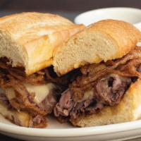French Dip · All natural Angus beef, melted Swiss, frizzled onions, and homemade au jus for dunking. Serv...