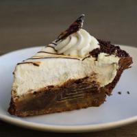 Rio Grande Mud Pie Slice · Dense rich chocolate filling baked in a chocolate cookie crust, topped with homemade caramel...