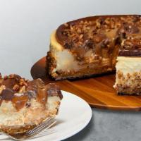 Turtle Cheesecake Slice · Rich vanilla cheesecake infused with caramel, topped with chocolate ganache, thick ribbons o...