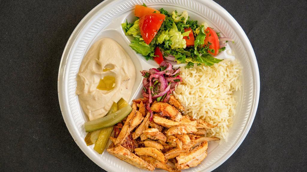 Chicken Shawarma Plate · Served on pita bread with fries, hummus and garlic sauce.