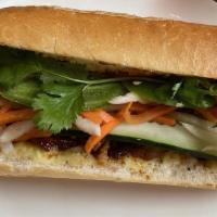 Lemongrass Pork Banh Mi · Grilled lemongrass pork, cilantro, pickled carrot & daikon, jalapeno, cucumber, house aioli.