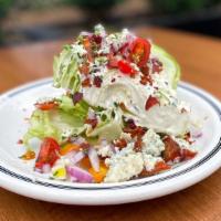 Bleu Cheese Wedge Salad · Iceburg lettuce, heirloom tomatoes, red onions, pecan smoked bacon & bleu cheese dressing.