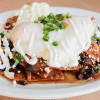 Chilaquiles · Local tortilla chips in house red sauce, two cage-free OE eggs, slow-cooked pulled pork, bla...