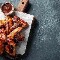 Buffalo Wings With Bbq Sauce · Delicious Chicken wings tossed in buffalo sauce and fried to perfection. Served with BBQ Sau...