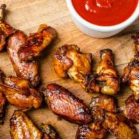 Buffalo Wings With Honey Hot Sauce · Delicious Chicken wings tossed in buffalo sauce and fried to perfection. Served with Honey H...