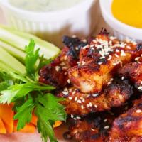 Boneless Wings With Singapore Hot Sauce · Delicious Boneless Chicken wings fried to perfection, served crispy. Served with Singapore H...