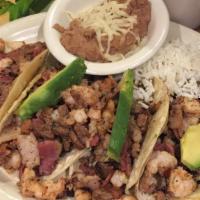 Tacos Al Patron · Four soft fried tacos with a combination of beef, shrimp, bacon, onions, tomatoes, and avoca...