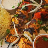 Tavuk Shish Kabab · tender, juicy marinated chicken breast slowly and fully grilled, served with Turko rice , sa...