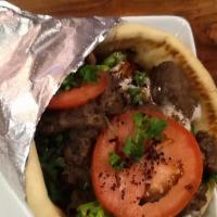 Döner Kebab Pocket · Döner kebap, home-made tomato sauce, grilled eggplant and yogurt sauce, salad greens and cru...